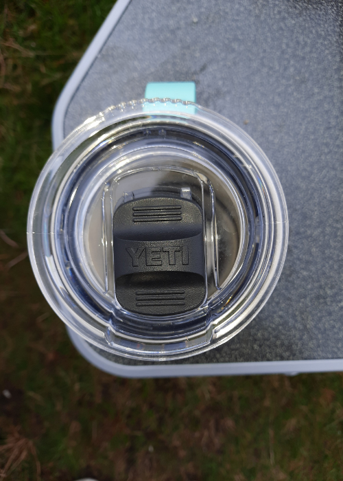 Yeti Rambler sitting in a cup holder on Coleman Deckchair