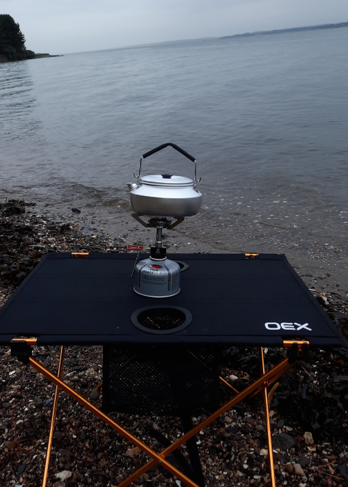 OEX Etna Mini Stove supporting Trangia Kettle on OEX X Lite Table