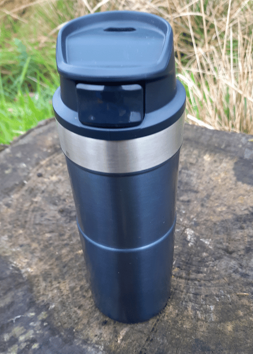 Yeti Rambler sitting in a cup holder on Coleman Deckchair